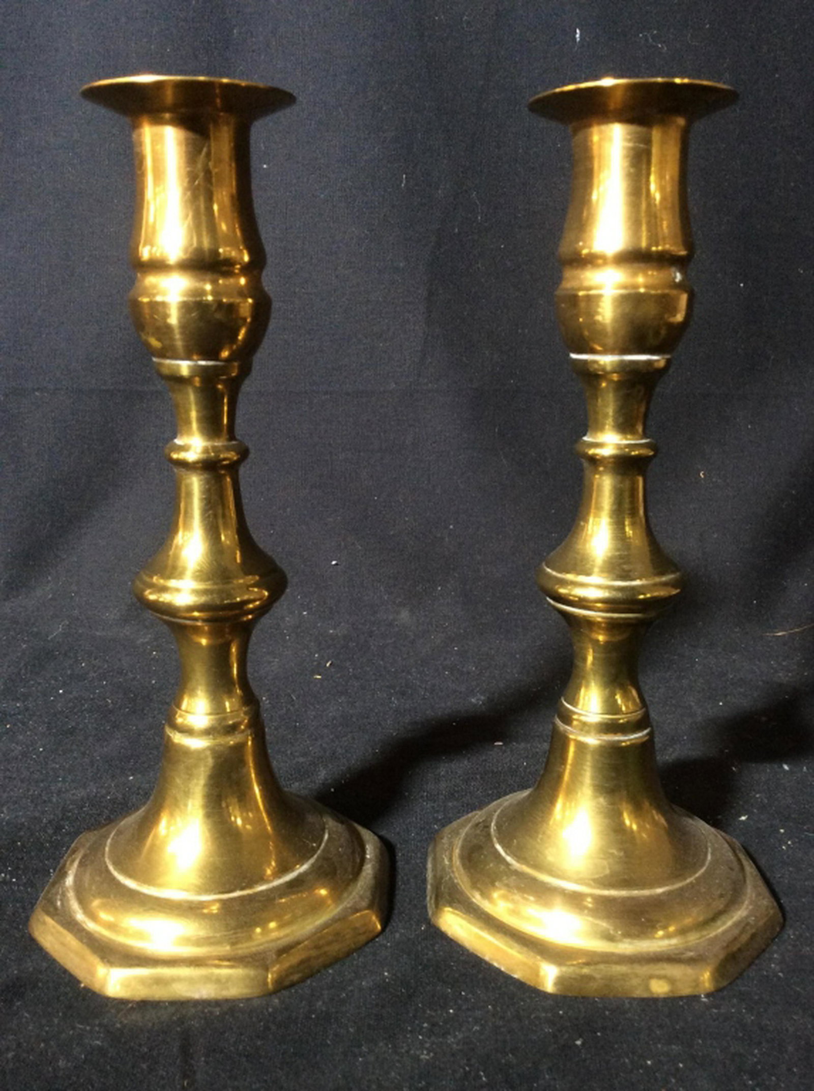 Pair Gold Toned Brass Candlesticks Candlesticks appear: Candlesticks appear to be brass. Pieces are gold toned. Each measures approx 7.25 inches tall 3.5 inches wide. candlesticks, tableware, home acent, decorative accessories 6.