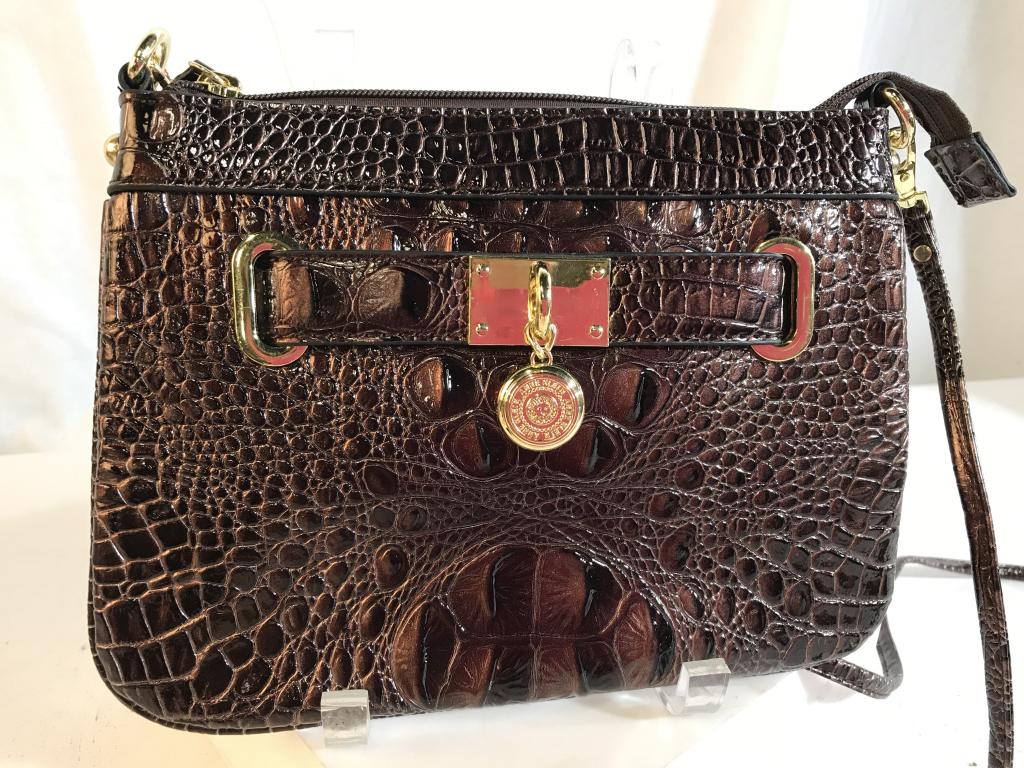ANNE KLEIN shoulder/cross-body bag: Anne Klein logo displayed on medallion on front. Reptile pattern exterior, dot pattern lining on interior. Detachable strap. Made from man made materials. Bag measures 11 inches diagonally. Three inte
