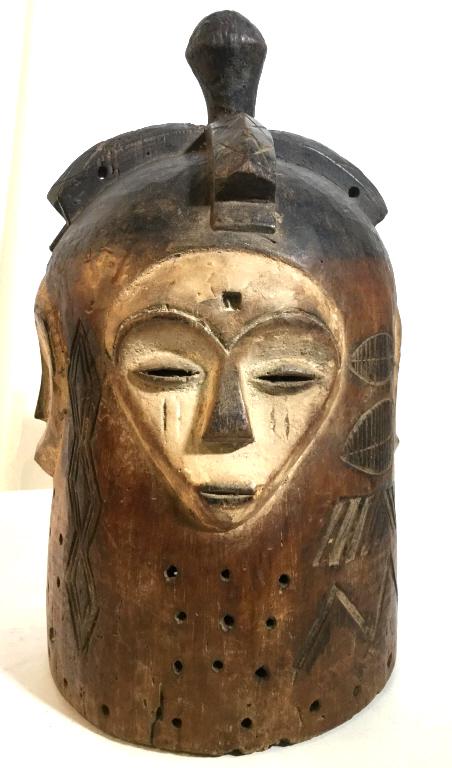 African Art Ngontang Helmet Mask, Gabon Carved wood: Carved wood ngontang spirit helmet mask from Gabon, Central Africa. Wood helmet mask has multiple faces, along with pierced and etched elements throughout. Mask measures approx 15.75 inches in height 