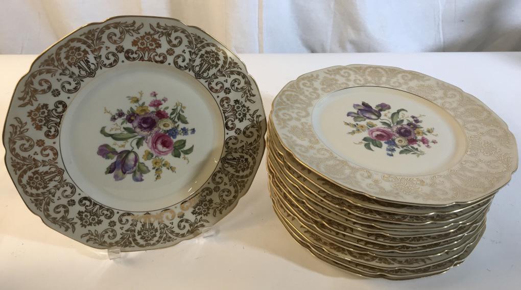 Set 12 porcelain floral plates Flowers: Flowers depicted in the middle with gold colored floral accent on the outside. Plates measure approximately 11 inches in diameter. Made by Heinrich & co. Floral plates, porcelain plates, set 12 plates
