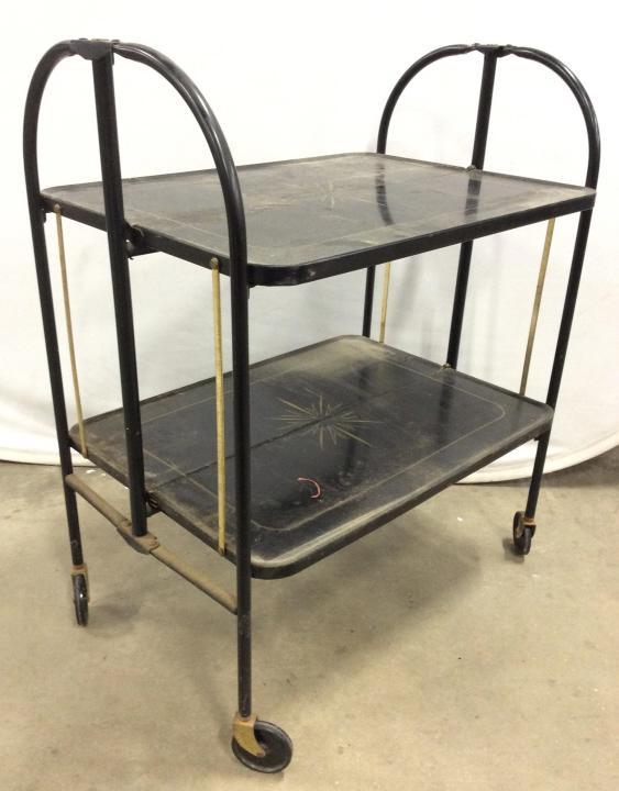 FOLD N ROLL Versa Table Beverage Cart: Underside has tag which reads FOLD N ROLL VERSA TABLE. Piece appears to be vintage. piece is black and gold toned. Beverage cart is metal. Piece has 4 wheels. Measures approx 32 inches tall 25 inches