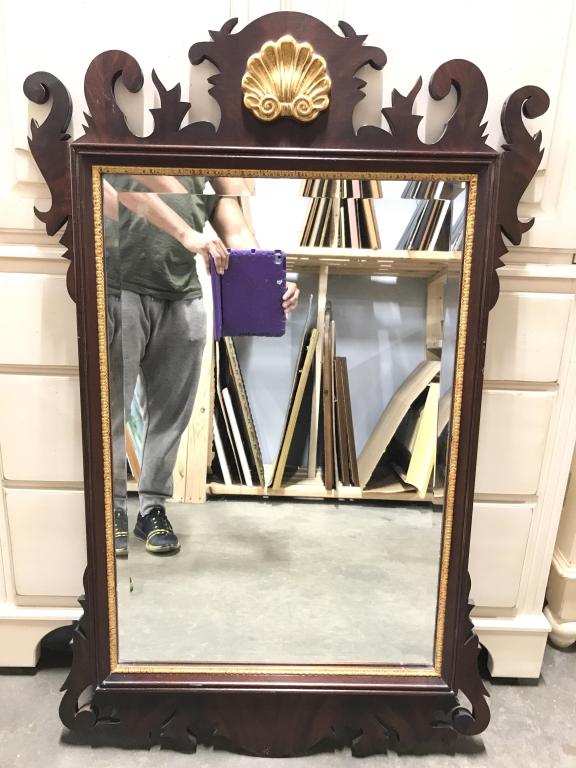 FANCHER FURNITURE CO Wooden Frame Mirror: Tag on backside reads FANCHER FURNITURE CO. Frame of mirror has intricately carved wooden detail. Top center of piece has gold toned coquillage style Detail. Piece measures approximately 46 inches tal