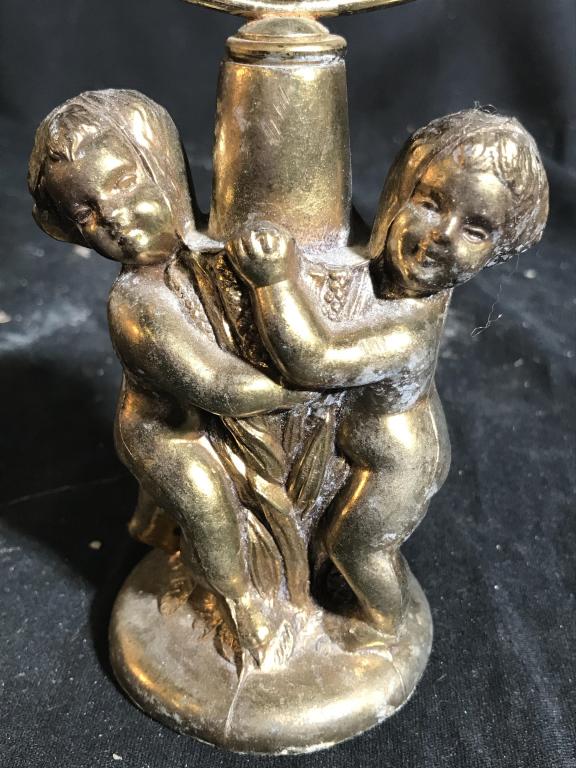 Gold Toned Metal Cherub Shaving Mirror: Piece is gold toned possibly brass. Base has 2 cherub Figurals. Mirror is circular. Measures approx 11 inches tall 7 inches wide. shaving mirror, dresser top table, vanity mirror, home accessory, deco