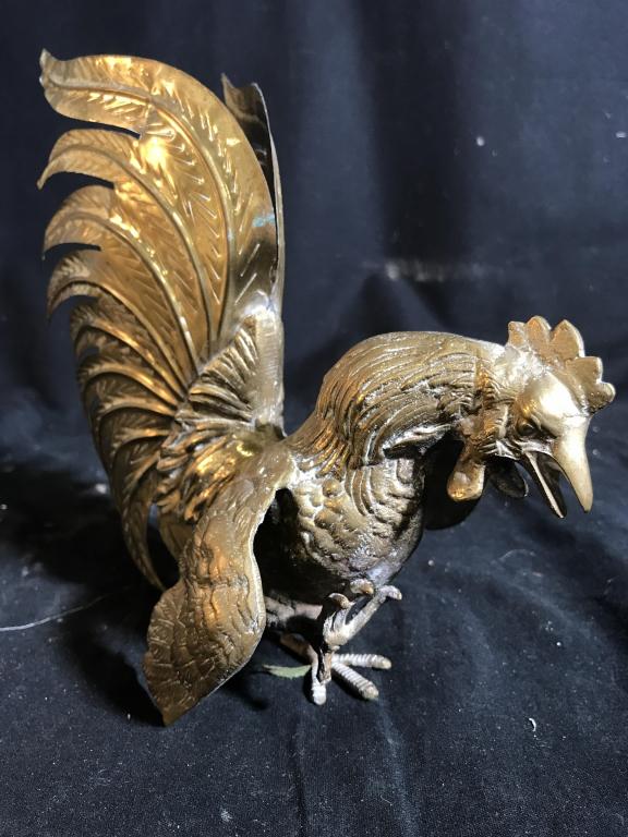 Gold toned Brass Rooster Figural: Rooster Figural is gold toned possibly brass. Depicts a rooster walking. Piece measures approx 9 inches tall 9.5 inches deep, 5.5 inches wide. decorative accessory, home accent and decor, farmhouse de