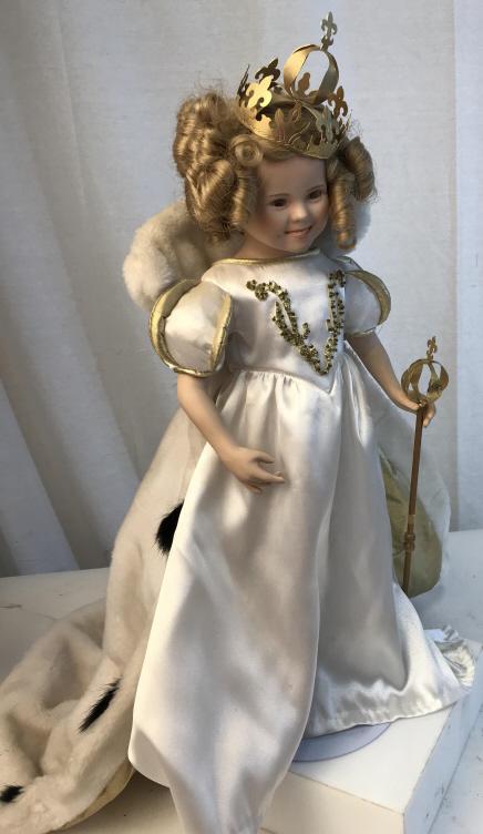 Vintage Porcelain Princess doll: Comes with stand and accessories. Doll stands at approximately 18 inches tall. Includes doll, stand, septar, crown, and cape. Doll is wearing a white dress with gold accents. Curly blonde hair, vintag