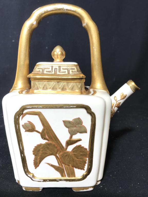 ROYAL WORCESTER Cream & Gold Toned Teapot: Underside of piece has ROYAL WORCESTER Marking. Piece is cream toned with gold toned handle and floral & leaf detail. Piece measures approx 9.5 inches tall 8 inches deep with spout, 5 inches wide. App