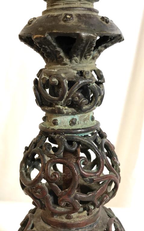 Bronze Toned Intricately Detailed Lamp: Lamp is bronze toned. Possibly bronze. Piece has intricate pierced c curve detail. Piece is vintage possibly antique. Measures approx 28 inches tall 4 inches wide. table lamp, home lighting and access