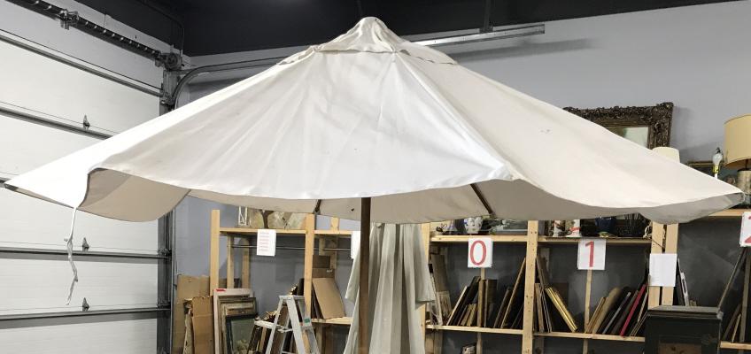 SUNBRELLA Outdoor Patio Umbrella: Label on interior reads SUNBRELLA. Piece is wooden & Metal. Piece has opening crank. Piece has black toned circular metal base. Piece measures approx 110 inches tall 114 inches wide. Needs cleaning. u