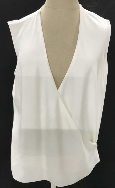 Stylish Jenni Kanye Designer Vest: All white with cross drape. Snaps on side then crosses to button on the other side. simple gold tone button. Material is acetate & a poly blend. Length, 25.5 in. Hips/ Waist approx 34 in. Dry Clean. O
