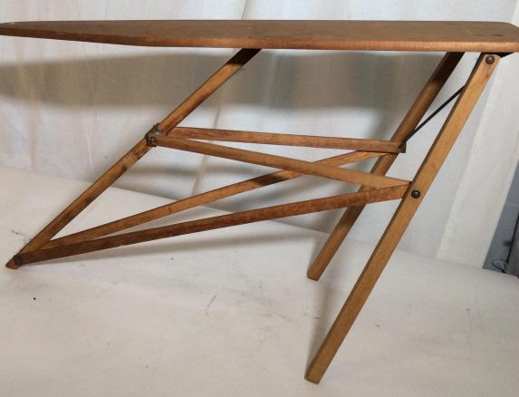 Vintage OUROWN Table NO. 34 SAGINAW MFG. CO.: Wooden ironing table. Metal hardware. Rusting On Hardware evident. Some wear. One nail head is sticking out. Stands approximately 22 inches tall. Is approximately 34 inches long. Vintage ironing board
