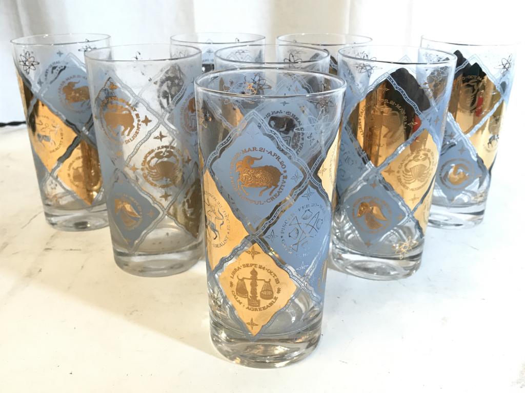 Lot 8 Zodiac Sign Glass Cups: Lot includes 8 glass cups. Each have tones of light blue & gold. Each measures approx 5.5 inches tall 2.75 inches wide. barware, drinking glasses, horiscope zodiacs, 6