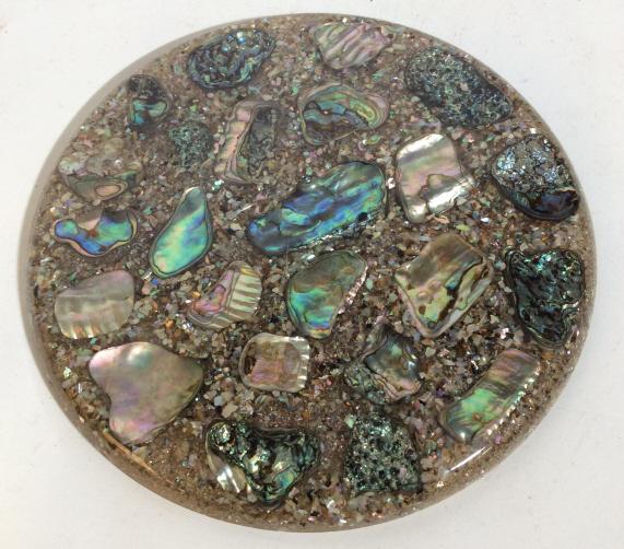 YIANNI HANDCRAFTED ABALONE SHELL DECORATIVE PIECE: Handcrafted in California by YIANNI. Created in Ghiradelli Square, San Francisco. Piece created using whole and fragmented abalone shells. Cork feet. Measures approximately 8 inches in diameter. Decor