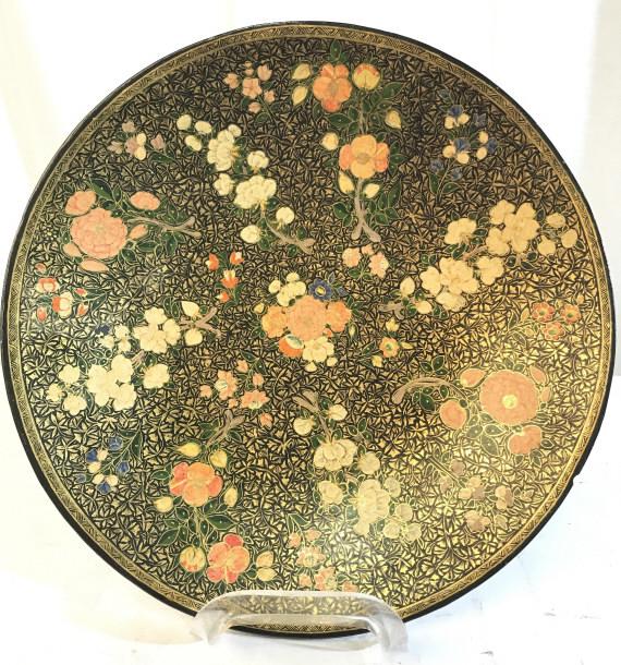 M. SADAK ALI & BROS Handmade Lacquer Plate: Underside has tag which reads HANDMADE M. SADAK ALI & BROS. Piece has intricate multi toned floral detail. Measures approx 11 inches wide. Contains some scratches and wear. centerpiece, shelf piece, d