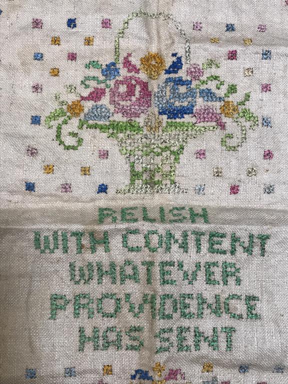 Colonial Motto Sampler W Flower Motif: Colonial sampler on linen. Sampler features the saying ‘relish with content whatever Providence has sent.’ Flower in Vase motif along top with floral pattern border. Sampler is unframed, measures 
