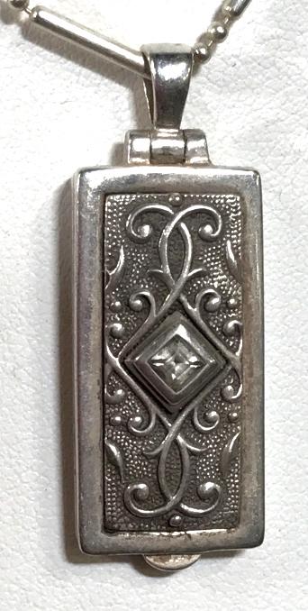 ANATOLI Sterling Locket Necklace W Gemstone: Marked Anatoli and 925 for sterling silver in interior of locket pendant. Exterior of pendant has pale tone gemstone, possibly topaz, possibly other semiprecious gemstone. Fully extended, necklace mea
