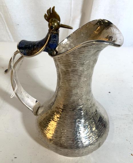 Los Castillo Bird Pitcher W Natural Stone: Los Castillo Bird Pitcher Silver Plate W Natural Stone. silver plated water pitcher with a bird Figural standing on top. bird figural has brass toned details and lapis lazuli style mosaic inlay. Pitch