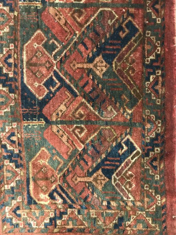 Antique TURKOMAN Rug: Rug is handmade and wool. Contains tones of dark olive, navy, cranberry & beige. Piece measures approx 55 inches long 21 inches wide. Contains some wear around edges. home accent and decor, decorative