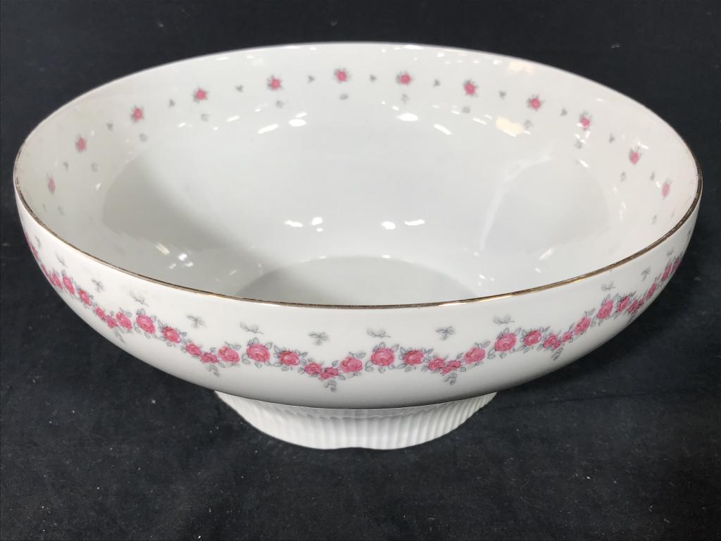 JLMENAU German Porcelain Centerpiece Bowl: Marked on underside for JLMENAU. Has rib texture base with pink tone floral border details and gold tone trim. Measures approx 4.25 inches in height by 9.75 inches in diameter. Some fading of gold ton
