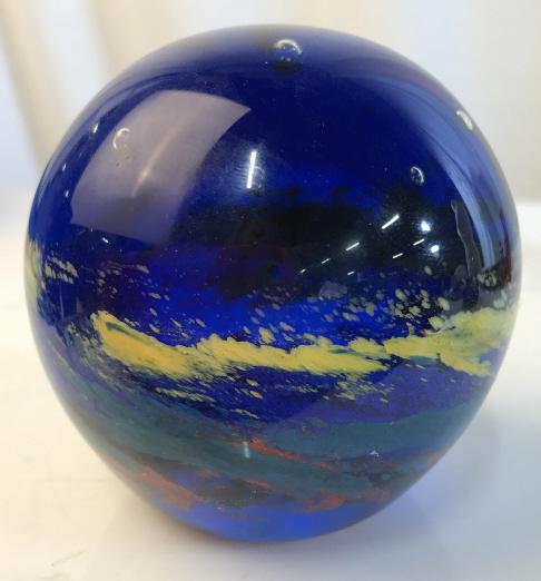 Multicolor ornamental Glass Paperweight: Multicolor Glass Paperweight with bubbles inside. Blue glass with yellow, green, and red stripes of paint decorated in the interior. Is approximately 4 inches tall and 4 inches wide. Paperweight, clas