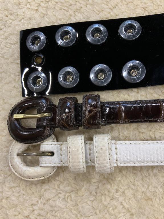Three Ladies Luxury Leather belts: Black patent leather belt marked for Michael Kora measures length 33 inches marked size six, white thin leather belt marked for WCM New York measures 34 inches and brown leather belt marked for WCM Ne