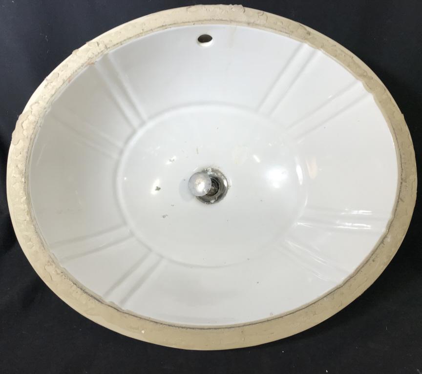St. Thomas Creations Under Mount Sink Basin: Marked on underside for St. Thomas Creations. Sink basin is ceramic, white in tone. Measures approx 10 inches deep, 19 inches by 16.4 inches in width and length. Silver tone hardware has significant s
