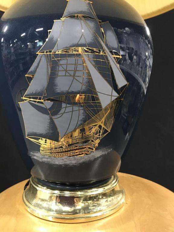 Pair SAILING SHIP Decor Table Lamps: Bright gold and hues of grey- blue painted Brig Ships on Ceramic or Glass (possibly) Vessel Lamp. Gold toned accents in base and top of body. Both have matching brass finials and light harps. Both hav