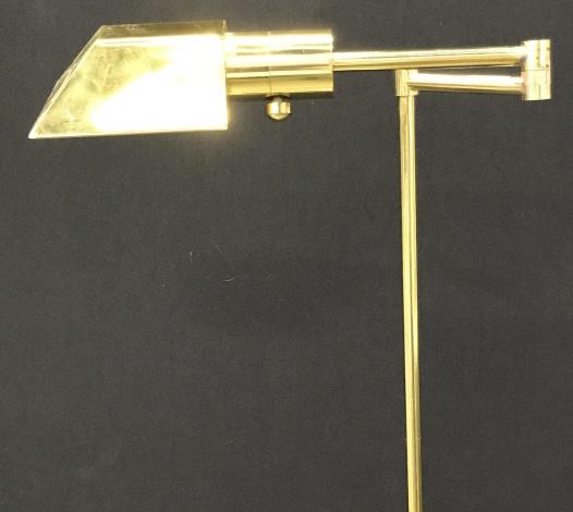 Brass Swing Arm Floor Lamp: Rotates in two different ways; by the light fixture, 360 degrees up/down. Knob to tighten, untested. Arm rotes horizontally 360 degrees. Also adjusts up and down with a pull/ push. Lowest pushes down 