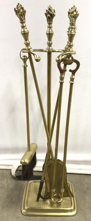 Lot 5 Gold Toned Brass Fireplace Tools: Lot includes shovel, broom, tongs grabber, stand, and poker. Handle of most pieces appear to have fire shaped detail. Measures approx 32 inches tall 10 inches wide 7 inches deep. home furnishings and 