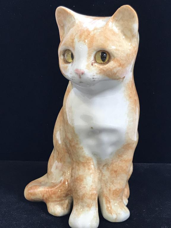 Artist Signed Ceramic Orange & White Cat Figural: Artist signed, illegible. Marked underneath, Made in England # 24 and sticker from Saks Fifth Avenue. Small nick on ear. No other surface issues noted. orange kitty measures 7 in. height, 5.5 in. widt