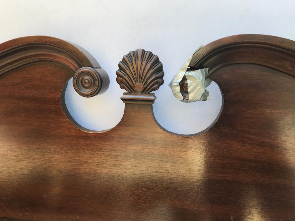 Wooden Poster Bed Frame W Clam Carved Detail: Lot includes headboard and footboard. Possibly mahogany wood. Intricate carved detailing. Headboard measures approx 63 inches in width by 56.5 inches in height. Some surface wear where areas are taped