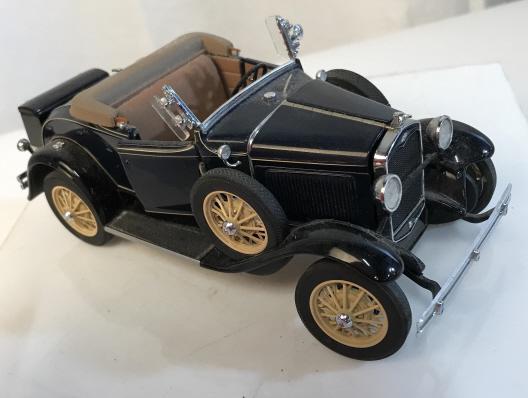 Vintage 1931 Ford Model A Roadster Model Car: 1:24 scale replica of an original 1931 Ford Model A Roadster. Vintage toy car, toy car, car replica, vintage car replica. Some parts may be missing. Comes with information and care sheet. Car is appro