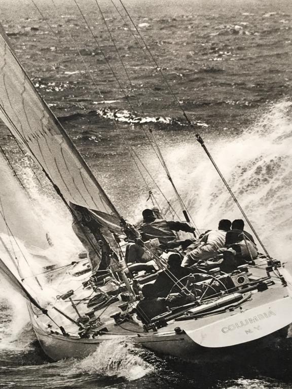 Framed Limited Edition Print Of Yacht Race Winner: Limited edition print number 700. Print depicts image of yacht named Columbia, the 1959 America’s Cup winner. Image is black and white in tone. Paper is set behind glass in wood frame. Some toning o