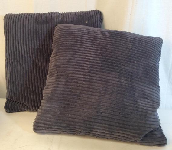 Pair smoke blue corduroy couch pillows: 2 smoke blue pillows measuring approximately 20 inches by 20inches. Made from soft, corduroy material. May be stuffed with feathers. Needs to be washed. Couch pillows, decorative pillows, soft pillows