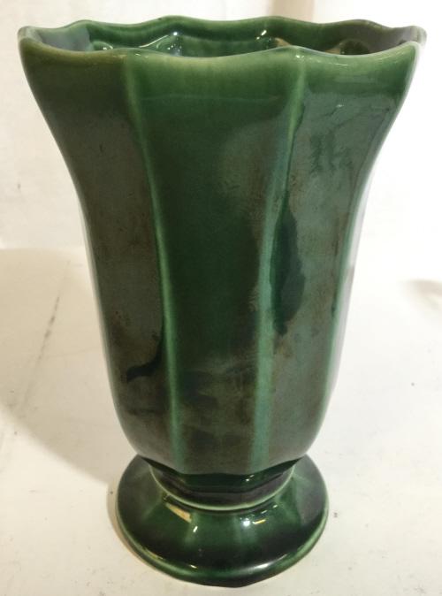 MCCOY USA Green Toned Ceramic Vase: Vase is Footed and ceramic. Piece is green toned. Measures approx 7 inches tall 5 inches wide. decorative ceramic pottery, vase vessel, tableware, shelf pece, 6.
