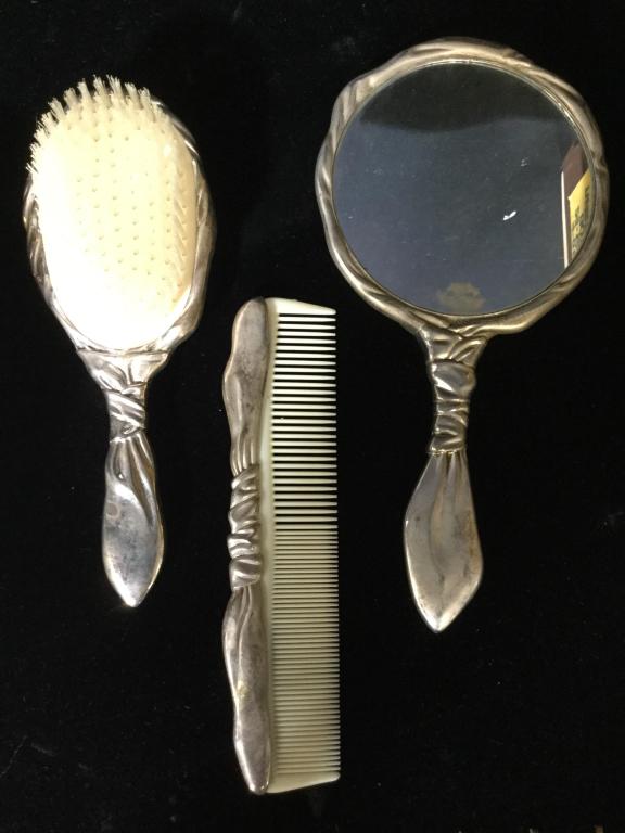 Lot 3 Vintage GODINGER Partial Vanity Set: Lot includes hand mirror, hair brush, and comb Hand mirror is marked GODINGER. Other pieces are unmarked. Each piece is silver toned. Possibly Silver plated possibly sterling silver. Brush and comb po