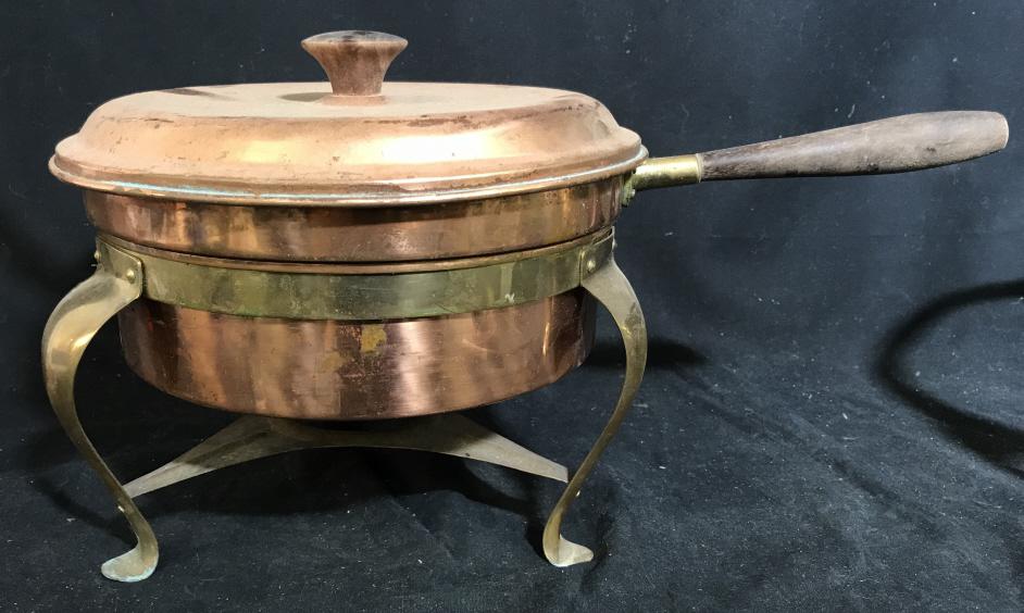 Lot 3 Mixed Metal Pot W Stands: Lot includes 1 mixed metal copper pot w brass details and wood handle, along with 2 mixed metal stands. Larger stand measures approximately 6 inches in height by 10.5 inches in diameter. Pieces have s