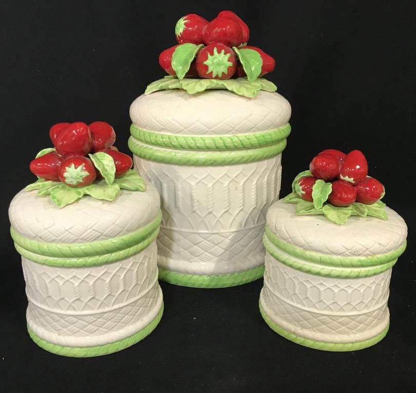 Set 3 Ceramic Lidded Jars W Strawberry Motif: Set 3 Ceramic Lidded Jars W Strawberry Motif, three different sized jars with white raised woven wicker design, green twist rope design around base and jar opening and topped with clusters of red stra