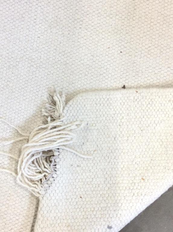 Cream Toned Handmade Wool Rug: Rug is cream toned handmade and wool. Measures approx 142 inches long 112 inches wide. Piece contains wear and some fraying at edges & corners. area rug, minimalist decor, carpet, woven rug 6
