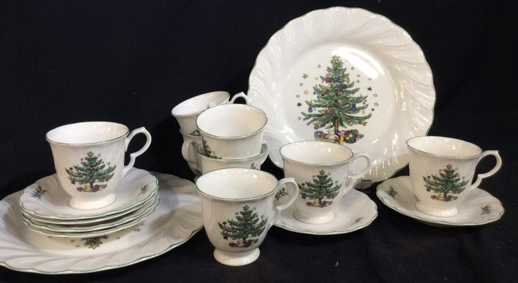 Set 16 Vintage NIKKO JAPAN Holiday Dishes: Set includes 2 approximately 11 inch diameter dinner plates, 6 6 inch diameter teacup plates, 8 3.5 inch tall teacups. Each piece is white ceramic with a Christmas tree printed on. Needs cleaning. Dis