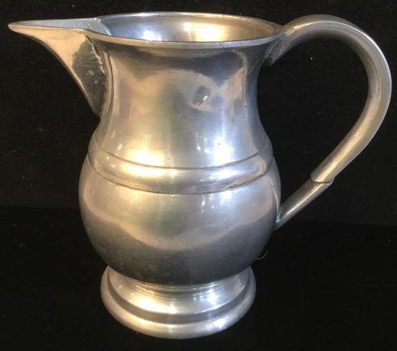 ADG Silver Toned Metal Pitcher: Pitcher is silver toned. Appears to be pewter. Underside of piece is marked ADG. Piece measures approx 6 inches tall 7 inches wide with Handle and spout.pitcher, tableware, tbaletop decor and accessor