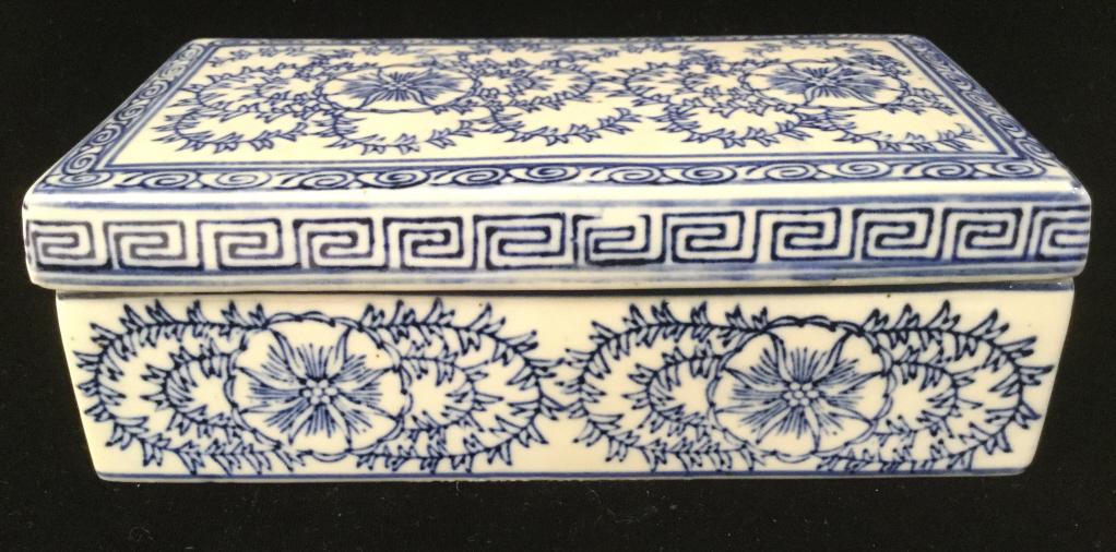 Vintage Asian Porcelain Keepsake Box: Piece is blue & White Toned. Contains painted floral & leaf detail. Measures approx 7.5 inches long inches deep 2.5 inches tall. trinket dish, keepsake dresser box asian arts and crafts, decorative ar