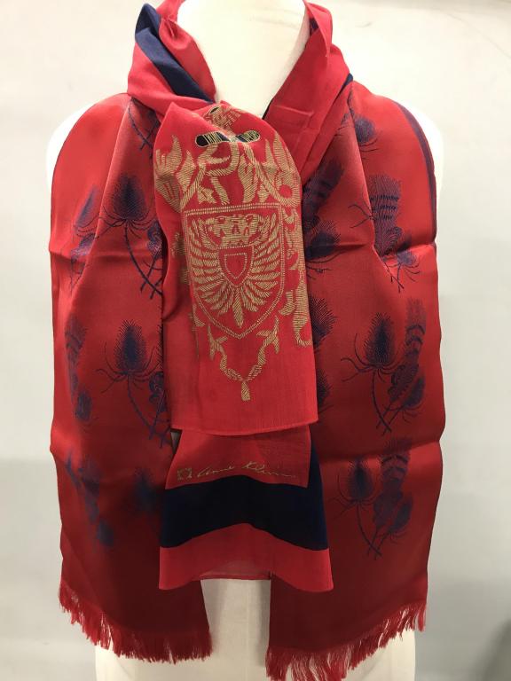 Lot 2 Designer Red Color Neck Scarves, A. Klein: Red scarf with Blue thread, feather motif. Small thread tasseling at end. Fabric, a couple sm imperfections. 12 x 46.5 in. Thick material. Possibly never worn. Crest Design Scarf, Designer Anne Klein,
