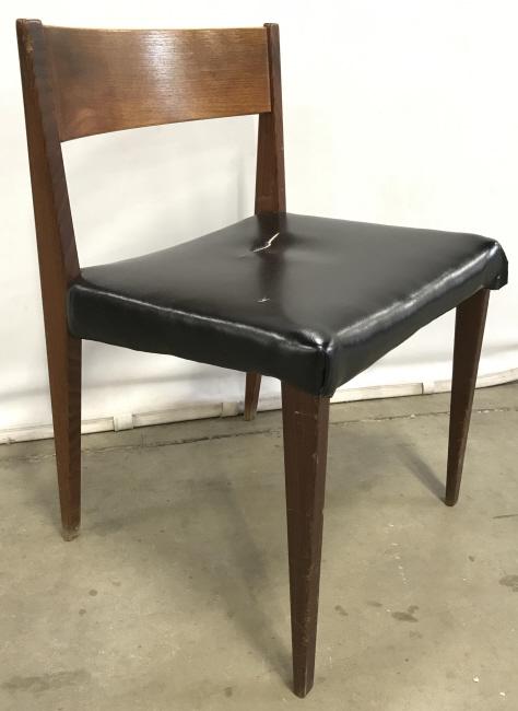 Mid Century Modern Wood And Black Vinyl Chair: Mid Century Modern Wood And Black Vinyl Chair with bowed backrest and tapered wooden legs, possibly Teak Wood, some chips and scratches to wood frame, rips to vinyl seat cover, measures approximately 