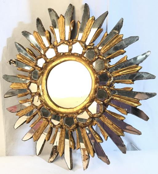 Vintage Gold Toned Wooden Sunburst Wall Mirror: Vintage Gold Toned Wooden Sunburst Mirror with gold toned painted finish, some pieces of mirror missing and cracks, measures approximately 15 inches in diameter x 1.75 inches deep. Vintage Wall Mirror