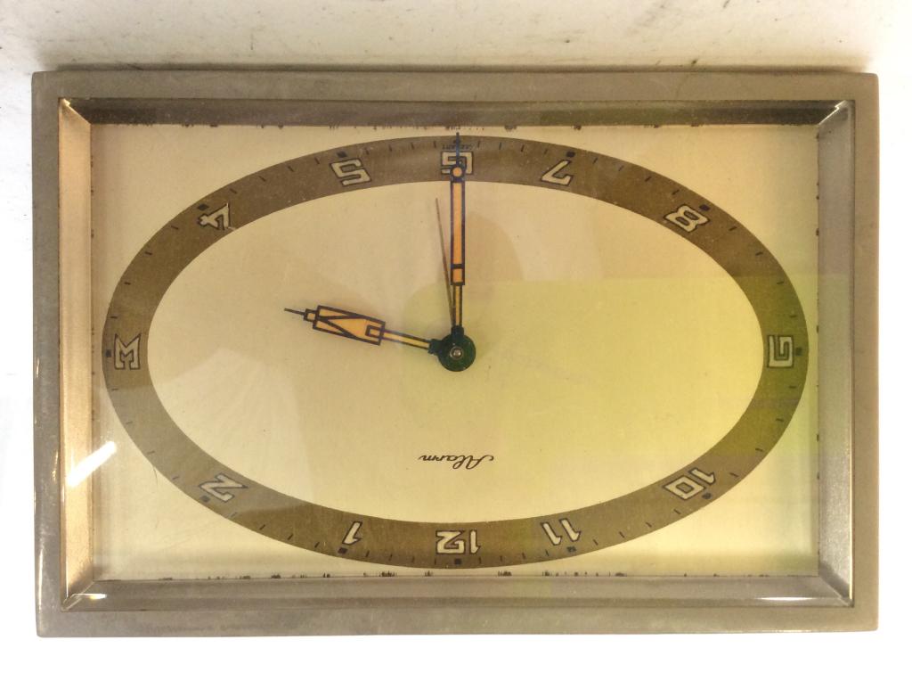 Vintage German ALARM Desk Clock: Clock face is marked ALARM. Backside is marked MADE IN GERMANY. MEASURES approx 6 inches long 4 inches tall. Contains some wear. mantle piece decor, shelf piece, home accent, decorative tableware 6