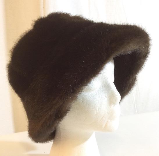 La Madison De La Fausse Fourrure Hat: La Madison De La Fausse Fourrure Hat Made in Paris From Saks Fifth Avenue, Made in the style of brown fur, brown satin style lining with embroidered animal paw prints, tags on interior read Saks Fifth