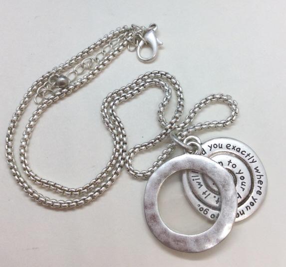 Silver Toned Metal Photo Locket Necklace: Light silver toned chain necklace with two charms, one with inscription “listen to your heart, it will lead you where you need to go”, one with open center for small photograph. Measures approx 10