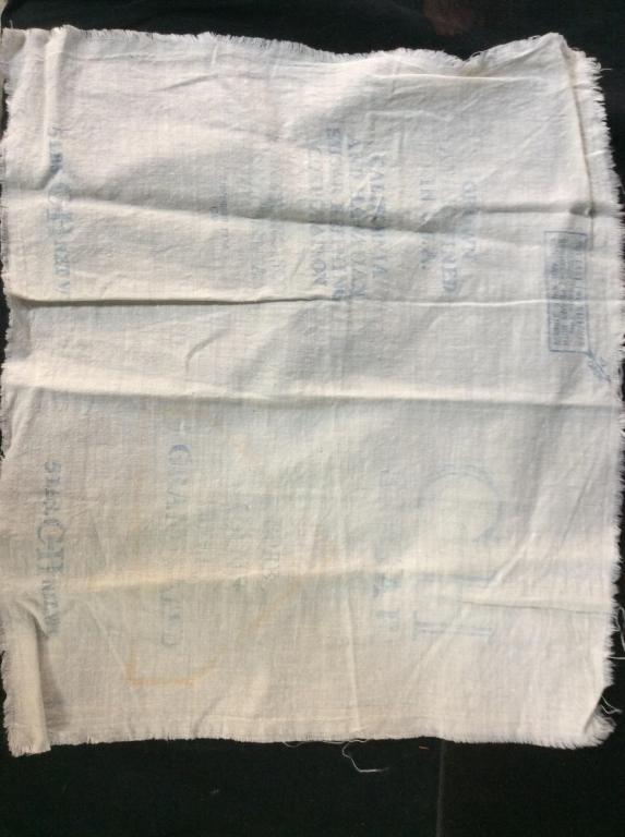Antique Feed Sack Cotton Linens, Lot 2: Pieces of sacks from back when sugar goods were transported in fabric bags called feedsacks. By the late 1800s, Cotton replaced burlap and canvas material. Faded wording. One reads ‘ Arbuckle Cane S