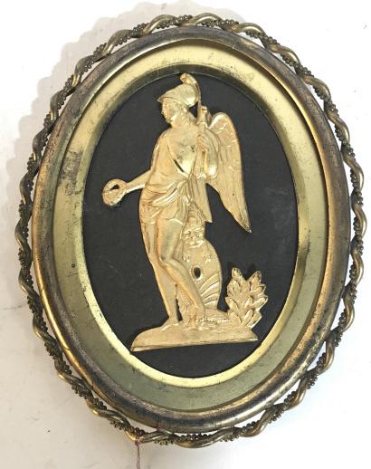ANTIQUE FRENCH METAL FRAMED ART circa 1870: Antique French art piece of a man wielding weapons and armor atop, a bird beneath his foot and a lion above the shield. Possibly gold plated. Measures approx 7.5 inches long. May need cleaning. Back r