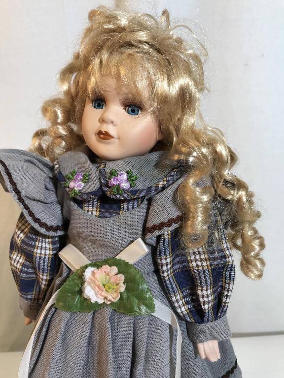 Vintage collectible porcelain doll with stand: Vintage possibly antique porcelain doll. No evident markings of brand. Hands, Face, and legs are porcelain. Possibly hand stitched clothing. Leather shoes. Stands approximately 16.5 inches tall. Paint